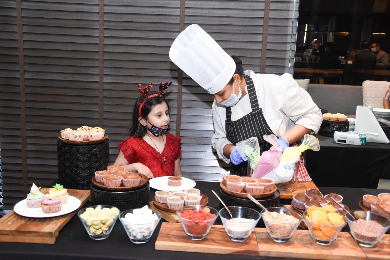 Novotel Chennai Chamiers Road Exterior photo A child learning cooking