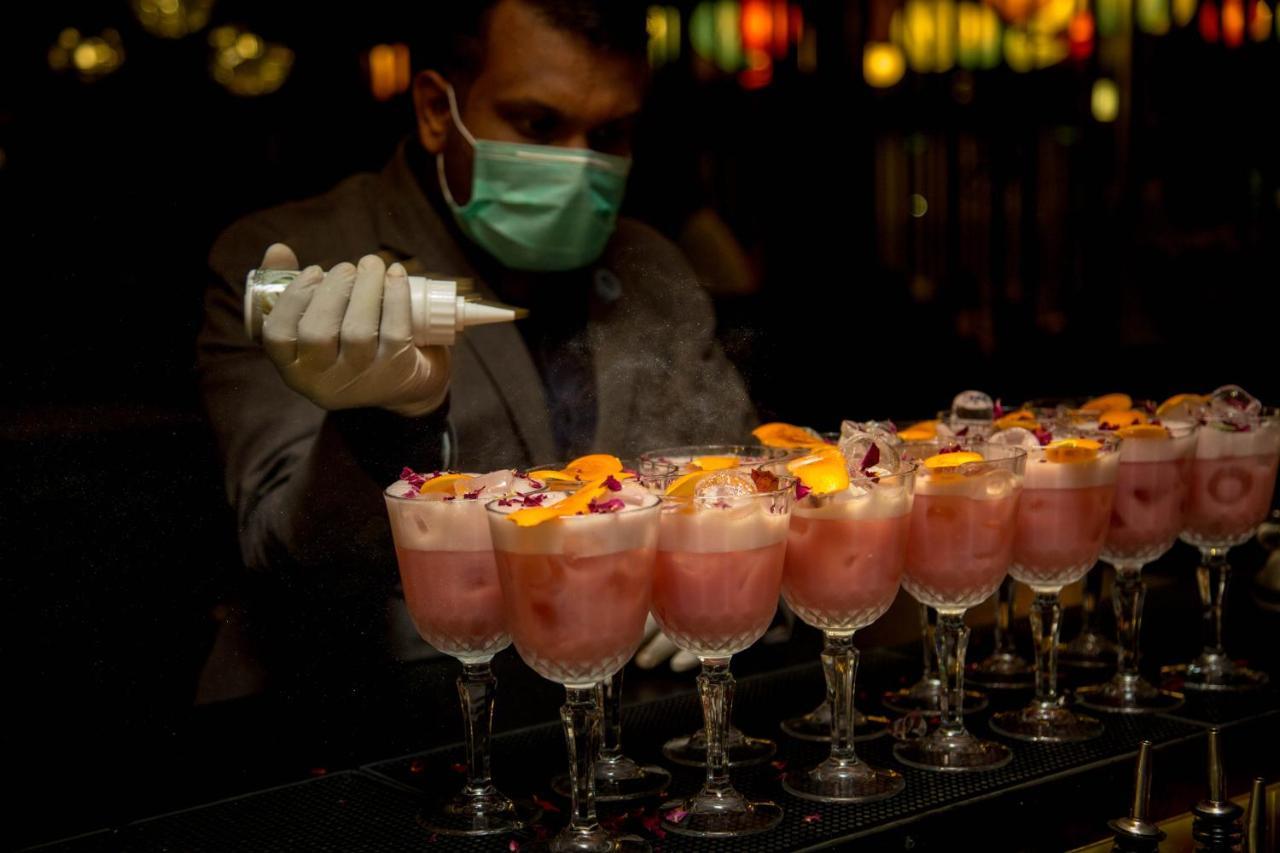Novotel Chennai Chamiers Road Exterior photo A bartender wearing a face mask in a nightclub in Dubai, United Arab Emirates